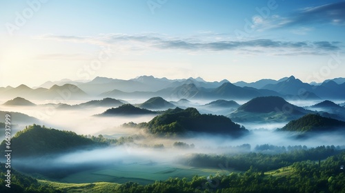 Aerial view of green hills with fog at sunrise