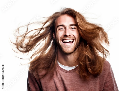 Young man with wavy long hair and a broad smile, dressed in a neutral beige shirt. Ideal for projects on contemporary fashion, hair care, or capturing radiant youthfulness.