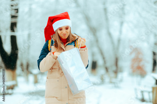 Unhappy Woman Checking her Gift Bag being Ungrateful. Upset lady feeling underwhelmed by holiday seasonal stress
 photo