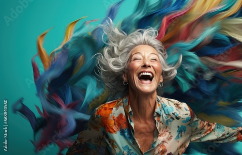 An exuberant woman with silver hair laughs heartily, surrounded by a whirlwind of colorful fabric. Ideal for creative campaigns emphasizing joy and vitality at any age.