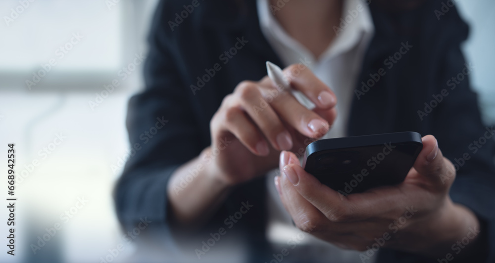 Close up of businesswoman using mobile smart phone and digital tablet computer at office. Asian business woman hand holding smartphone, connecting the internet, online working, corporate business - obrazy, fototapety, plakaty 