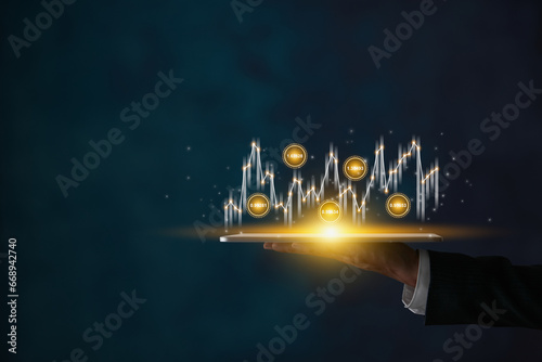 Businessman Hold Tablet and Stock Market Graph and Number Value in Dark Tone