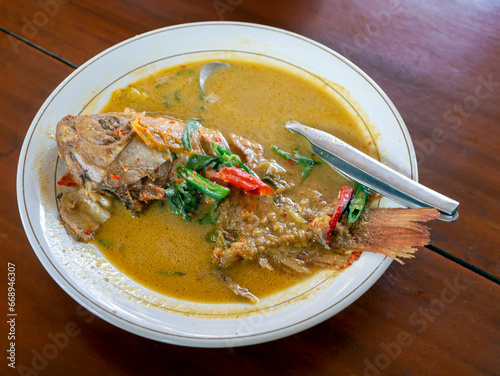A delicious tilapia or mujair fish (Oreochromis niloticus) soup flavored with spicy chili photo