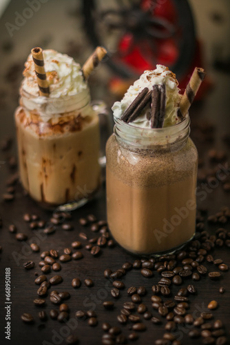 A variety of coffee drinks and smoothies with coffee beans on a table