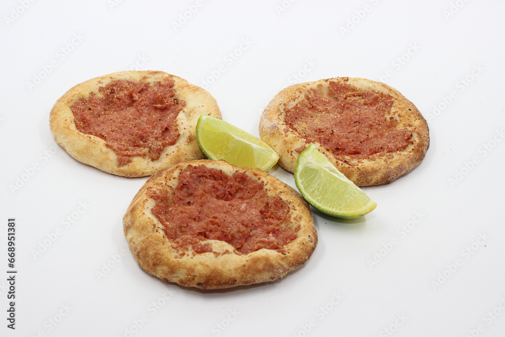 pepperoni sfiha with lemon on white background pepperoni sfiha with lemon on white background