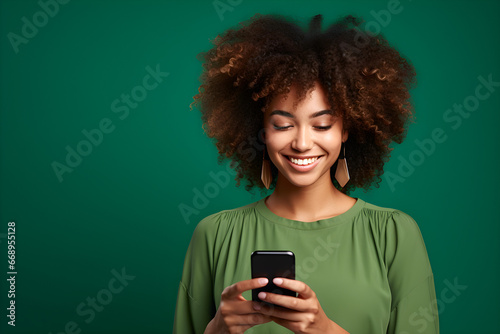 Young black woman engrossed in her smartphone, deeply focused on the screen, staying connected in the digital world