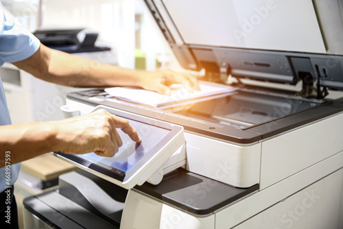 Hand use copier or photocopier or photocopy machine office equipment workplace for scanner or scanning document or printer for printing paperwork hard copy duplicate Xerox service maintenance repair. photo