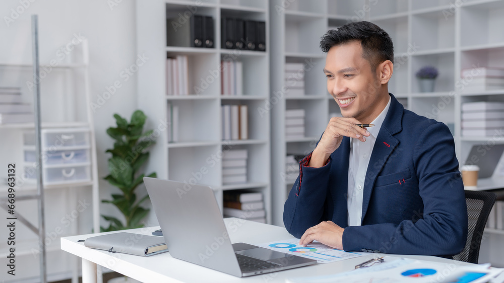 Asian businessman having conference video call using laptop talking to coworker online audience sitting at office. Consultation, webinar, tutoring on internet, telecommuting.