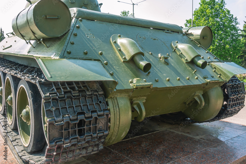 Suspension and tracks of the tank. Exhaust pipes at the back. Military technics. Tank on a pedestal. 