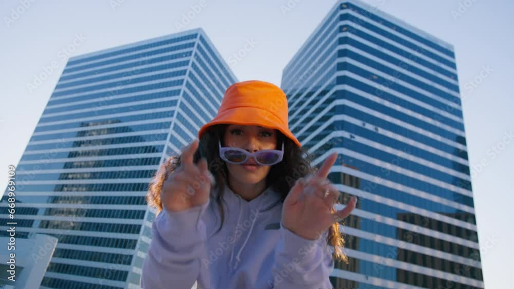 Happy beautiful african american woman dancing outdoor in downtown at sunset. Young mixed race carefree girl enjoys sunset and dancing. Black lady performing RnB moves in city cinematic RED camera 4K