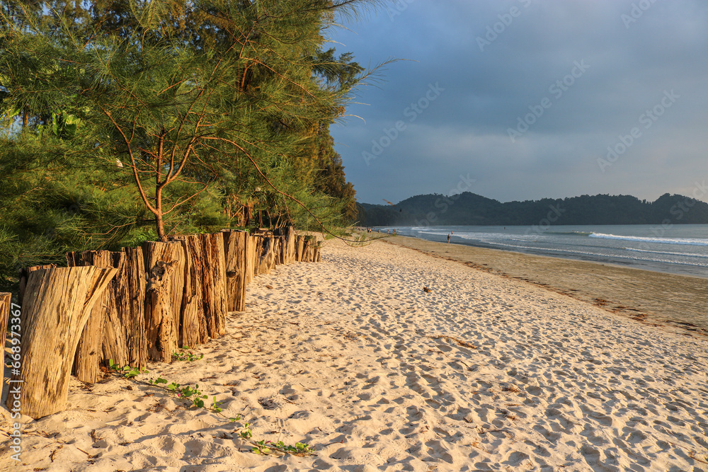 Sandy beach in beautiful sunset lighting. Tropical island of Koh Phayam, Thailand.
