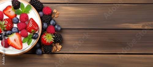 Healthy breakfast of Greek yogurt homemade granola and fresh berries on wooden background Top view