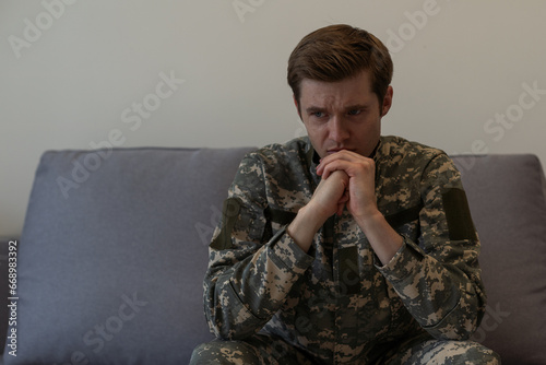 Thoughtful young handsome soldier in military uniform.