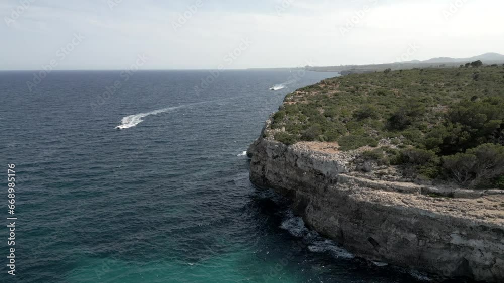 Aerial view catamaran sails along the coast. Slow motion 4K