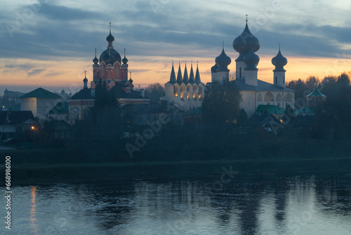 Ancient Tikhvin Assumption Monastery in October foggy twilight. Leningrad region, Russia