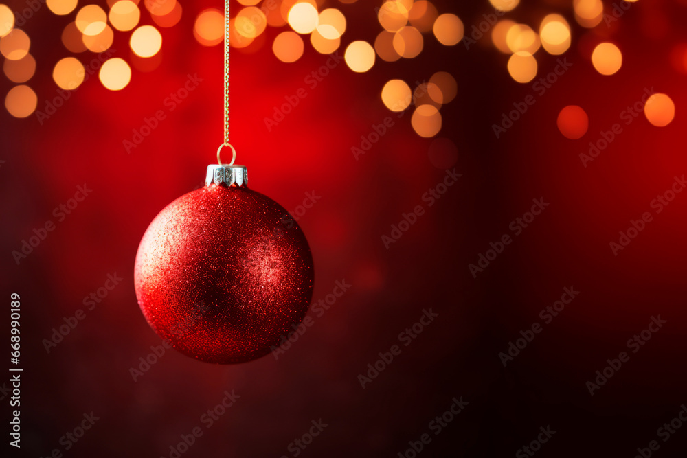 A red Christmas ball on a red background. Bokeh. 