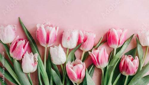 Lovely arrangement of spring blossoms. Bunch of tulips in delicate pink hues set against a soft, pastel pink backdrop. Perfect for Women's Day, and Mother's Day