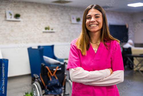 Smiling nurse wearing pink uniform in a nursing home photo