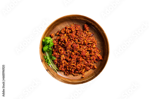 Traditional italian tomato sauce bolognese with minced meat in a wooden plate with herbs. Wooden background. Top view