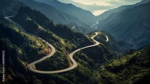 An aerial shot of winding mountain roads, carving their way through dense forests and steep inclines.