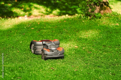 Smart Lawn Care. Robotic Lawn Mower in Action. Effortless Grass Trimming. Close-Up of an Automatic Lawn Mower