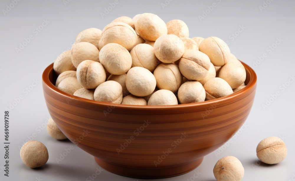 Macadamia Nuts in a bowl on white background. Macadamia Nuts in a bowl on white background.