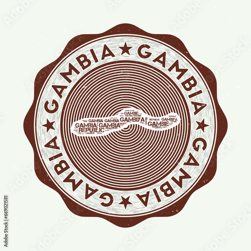 Gambia seal. Country round logo with shape of Gambia and country name in multiple languages word cloud. Authentic emblem. Awesome vector illustration.