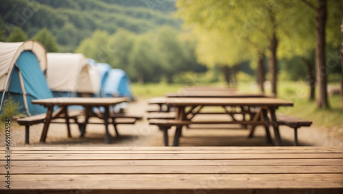 empty table with defocused background at camping site with tents
