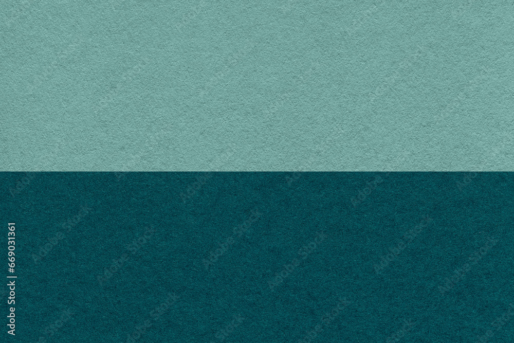 Fototapeta premium Texture of craft dark cyan and emerald paper background, half two colors, macro. Structure of vintage dense teal cardboard.