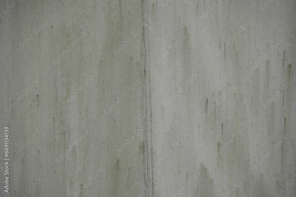 Old grunge canvas of grey tarpaulin. gray fabric texture from an old dirty piece of tarpaulin and seam. Texture old canvas fabric as background. Old grunge canvas of grey tarpaulin. gray fabric texture from an old dirty piece of tarpaulin and seam. Texture old canvas fabric as background.