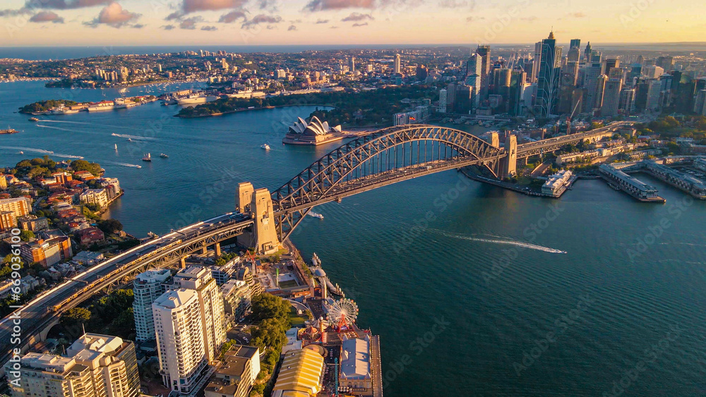 Aerial drone view of Sydney City and Sydney Harbour showing Sydney Harbour Bridge in the late afternoon     