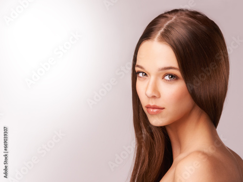 Woman, portrait and beauty or wellness in studio, makeup and skincare by pink background. Female person, mockup and brunette or natural, care and organic in facial treatment, space and aesthetic
