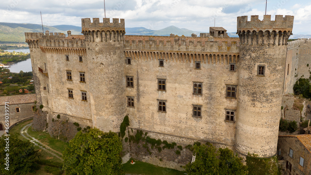 Aerial view of the Orsini-Odescalchi castle. It is a medieval castle in the town of Bracciano, in the metropolitan city of Rome, Italy. It overlooks Lake Bracciano.
