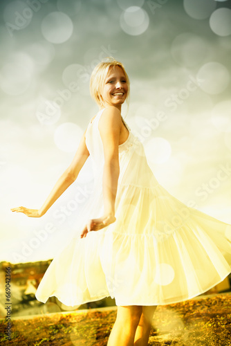 Smile, bokeh and blonde woman in dress in the countryside, dance and freedom outdoor in summer. Happy, nature and person moving with energy on holiday, vacation or celebration for travel on field