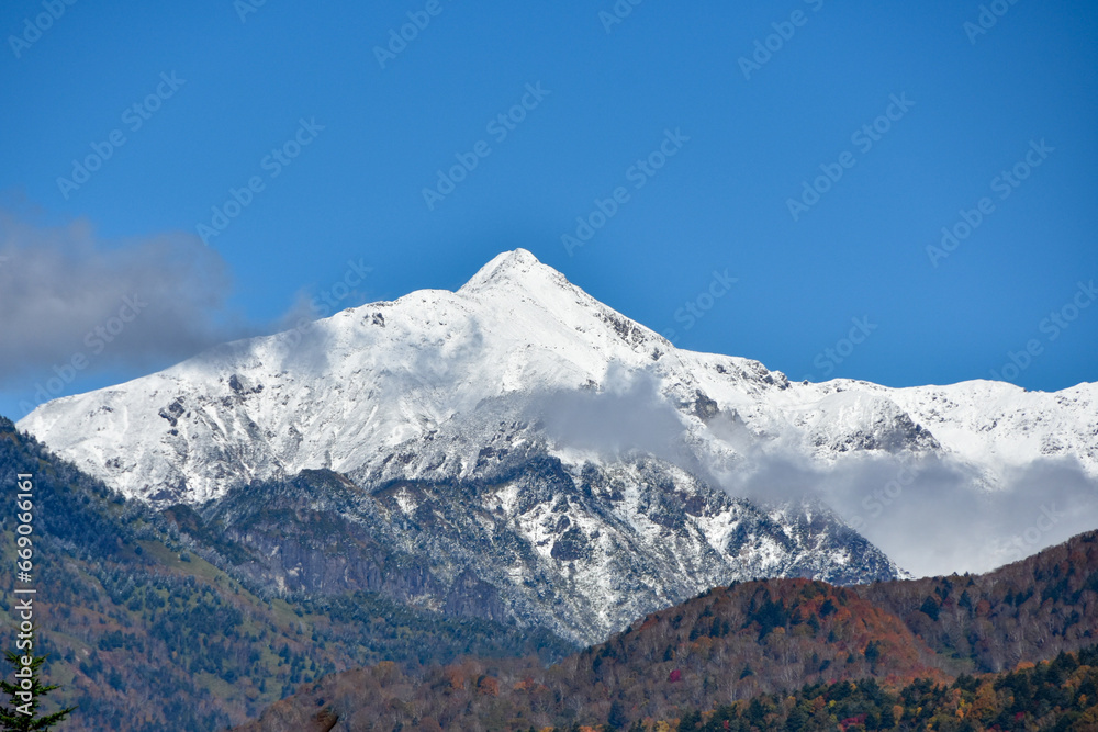 青空と冠雪した笹ヶ岳と紅葉