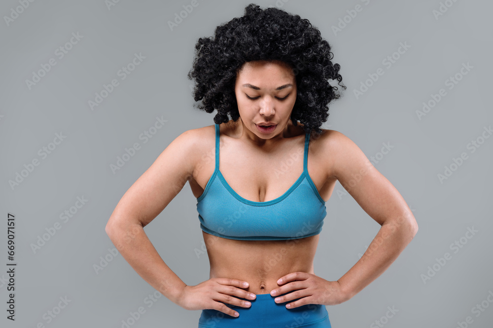 Woman breathing deep, rest after hard training in gym Woman breathing deep, rest after hard training in gym