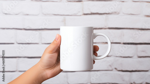 Hands holding a blank white coffee mug mockup.