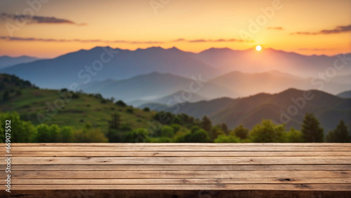 The empty wooden table top with blur background of mountain at sunset © adynue