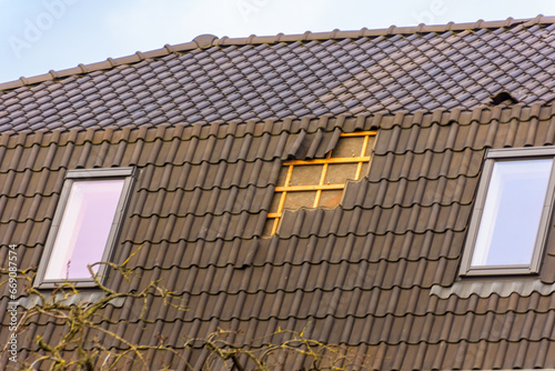 Damage to the roof from storm Eunice. A number of roof tiles have been blown away photo