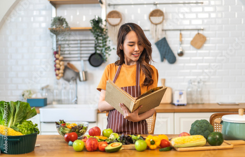 Portrait of beauty body slim healthy asian woman having fun cooking and preparing vegan food healthy eat with fresh vegetable salad  vegetarian on counter in kitchen at home.Diet.Fitness  healthy food
