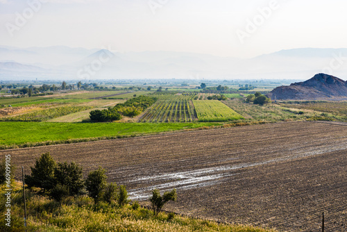 rural landscape in Ararat plain in Armenia on autumn day with fog on mountains on background photo