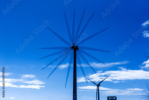Row of wind turbine generator, blue sky background. 