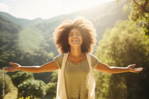 Happy woman surrounded by nature feels world around closes eyes taking deep breath. Smiling woman enjoys freedom feeling happy with closed eyes and taking deep breath.