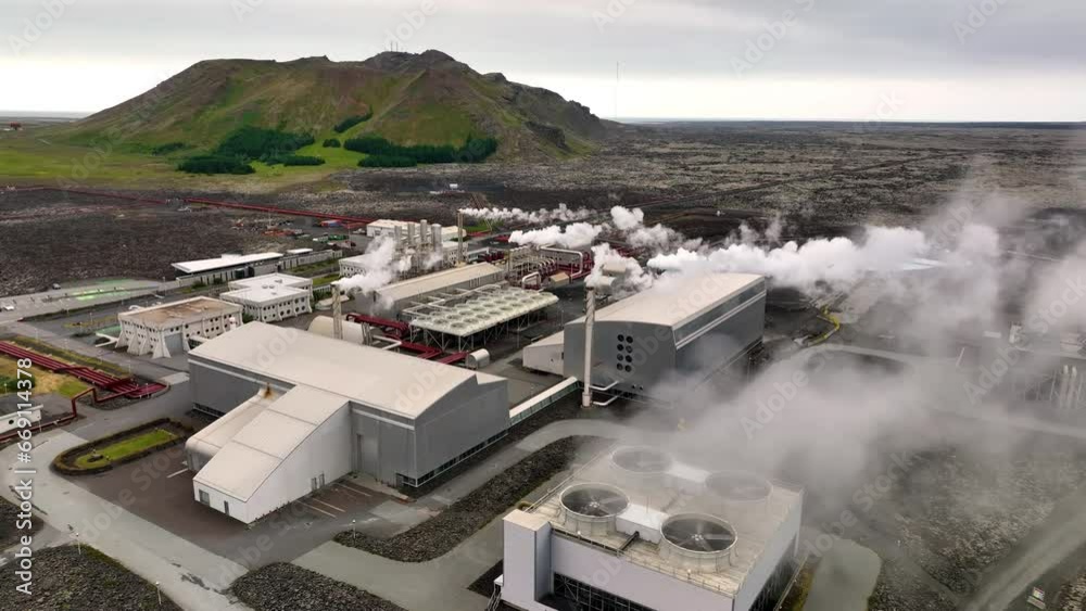 4K aerial video of geothermal energy plant, pipes and smoke chimneys. Iceland