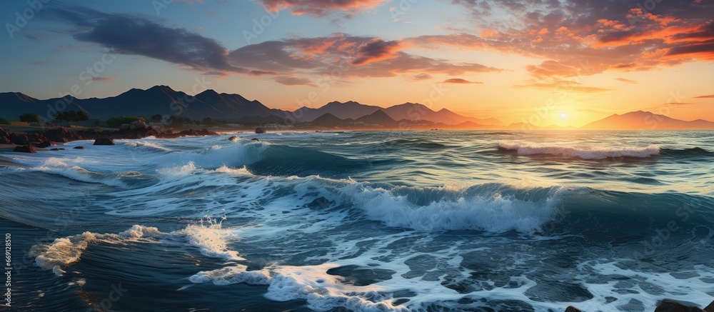 Blue Sea Waves. The sea water is in the shape of a peak. isolated beautiful sunset and clouds in the background