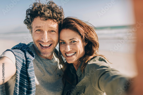 Close up portrait of a happy couple at the beach photo