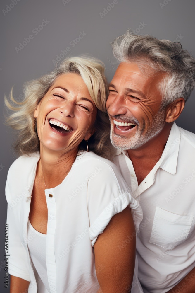 Vertical photo of a middle-aged couple sharing laughter sight reminding love source of joy and happiness. Grey-haired married couple in love sharing laughter serves reminder love wellspring of joy. Vertical photo of a middle-aged couple sharing laughter sight reminding love source of joy and happiness. Grey-haired married couple in love sharing laughter serves reminder love wellspring of joy.