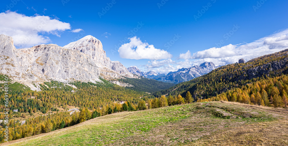 Panoramic view of a valley with golden larch trees in the Ampezzo Dolomites, Italy