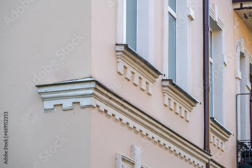 windows with decorative elements on an old wooden or brick building