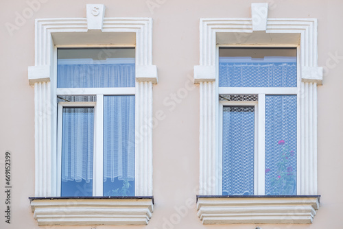 windows with decorative elements on an old wooden or brick building